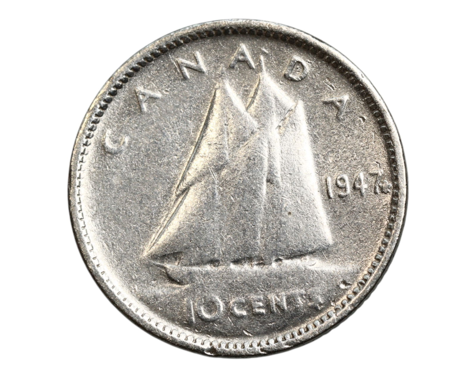 CANADA: George VI - Maritime Heritage Silver 10 Cents Coin, 1947, 18mm: Struck in the early postwar period, this 10 Cents coin offers a vivid homage to Canada's enduring maritime identity. Dominating the design is the iconic Bluenose schooner, rendered in full sail, symbo