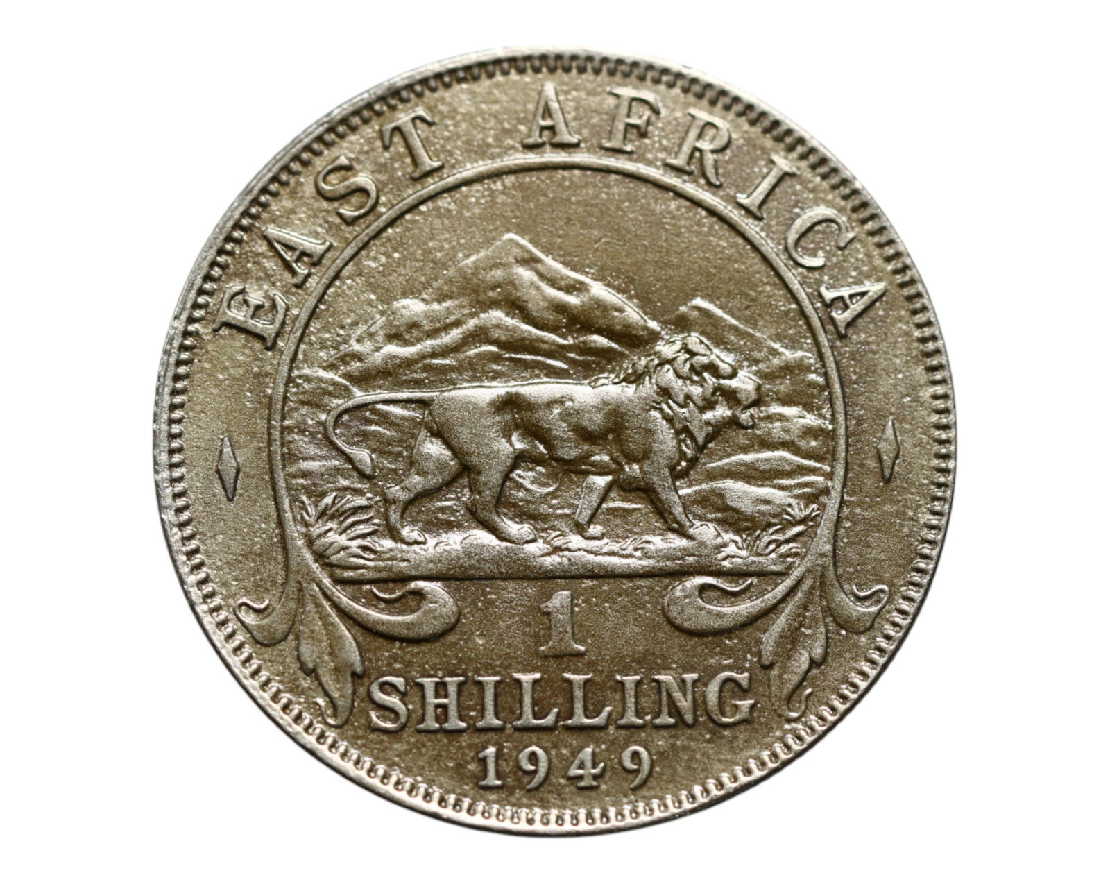 EAST AFRICA: King George VI - Imperial Lion Shilling Coin, 1949, 27mm: Struck under British colonial authority, this 1949 East African Shilling powerfully merges imperial iconography with regional symbolism. The crowned bust of King George VI evokes a waning but still po