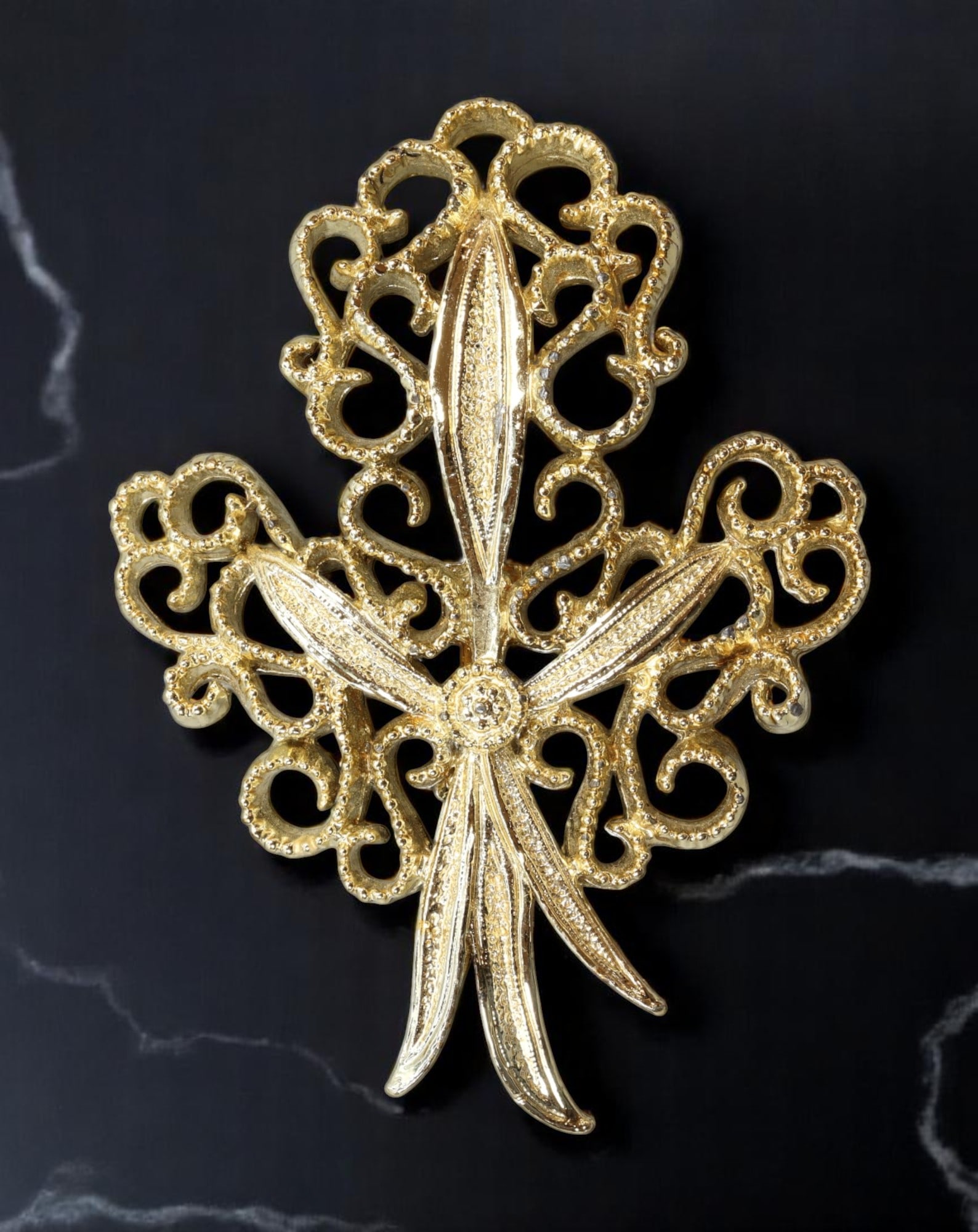 CERRIS: Brooch - Openwork Ribbon-Leaf Motif, Signed, 6.5x4.5cm: A finely cast mid-century brooch from the vintage designer Cerris, this signed piece merges scrollwork and naturalistic flair in a stylized ribbon-leaf form. The openwork frame contrasts with finely t