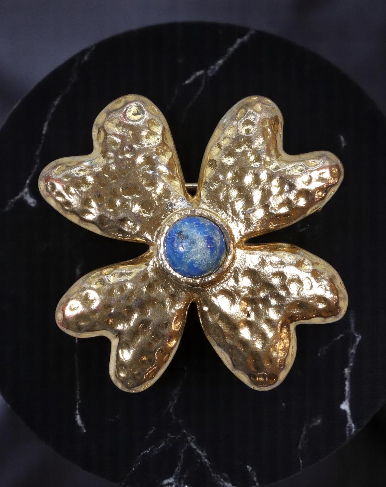 MODERN ROMANTIC: YR Brooch - Bold Clover Form with Blue Center Cabochon, Textured Goldtone (4cm): Evoking the playful elegance of mid-to-late 20th century studio design, this YR-stamped brooch presents a stylized four-leaf clover silhouette in richly textured goldtone. Each petal is softly contour
