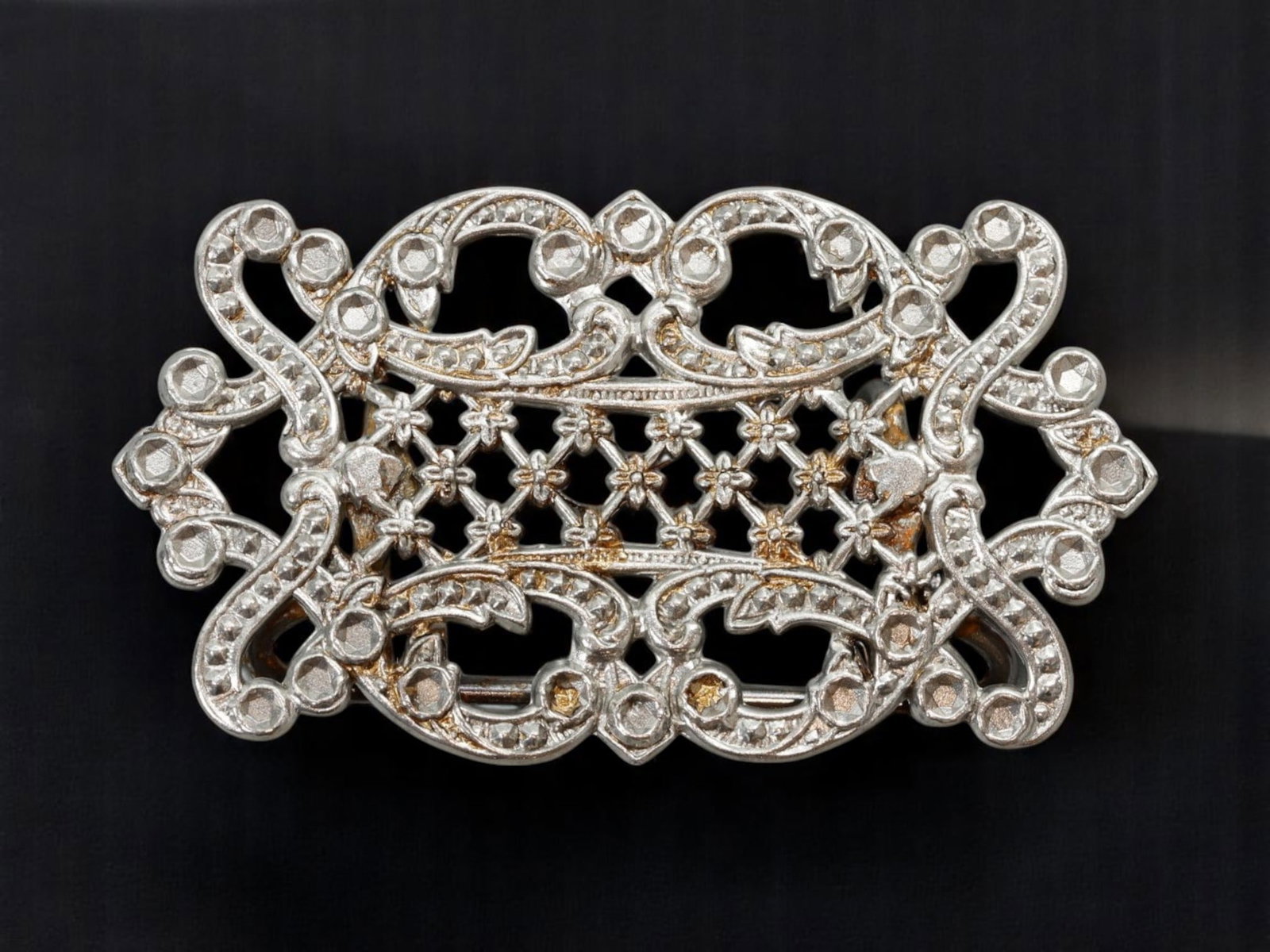 VICTORIAN REVIVAL: Buckle - Latticework Florals & Rococo Scrolls, Silvertone Openwork Frame: An elegant buckle blending Victorian romanticism with Rococo exuberance, this silvertone openwork piece features floral latticework framed by scrolling foliate forms and faceted bead motifs. The ornat