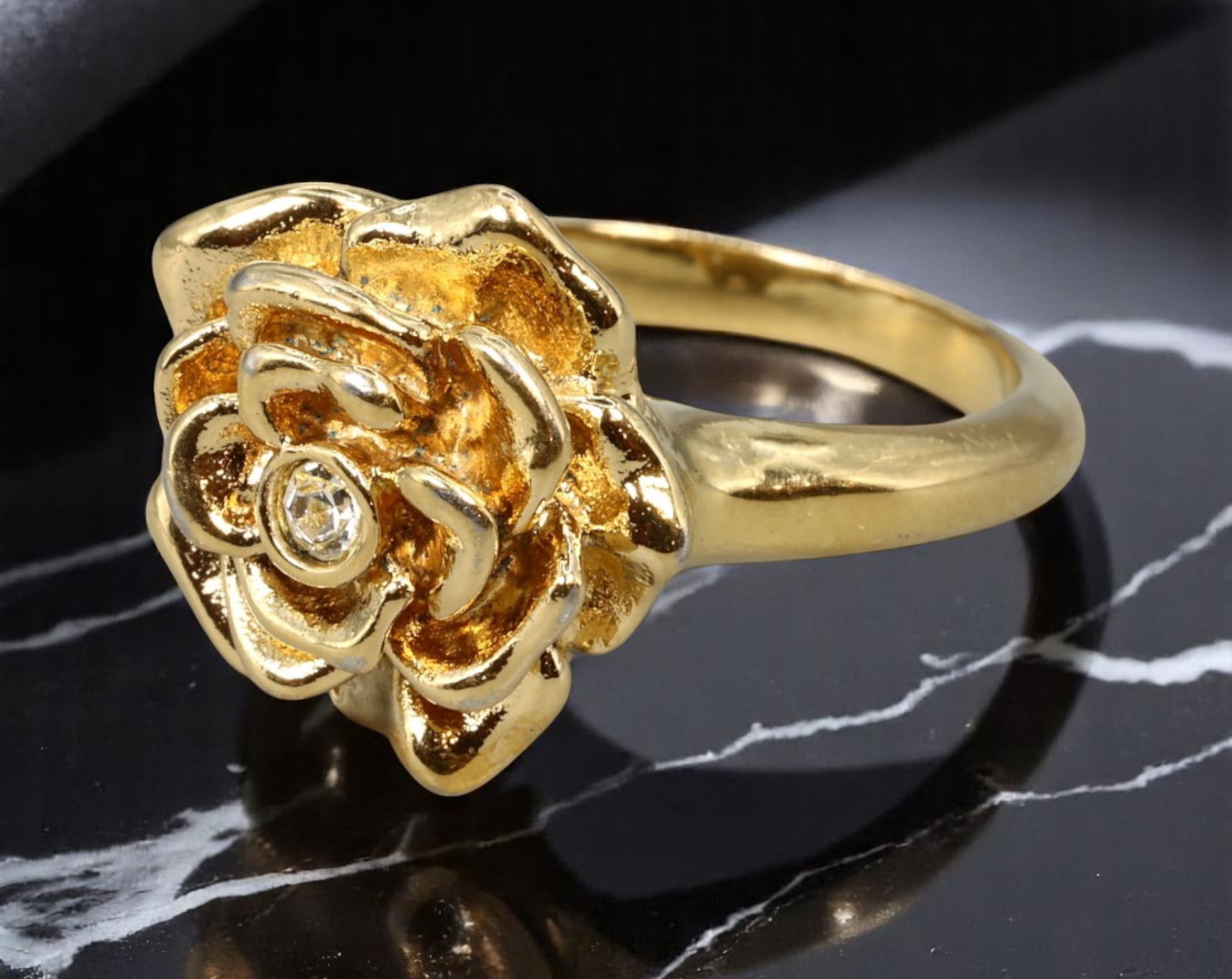MODERN ROMANTIC: Rose Motif Ring - Sculpted Bloom with Clear Center Stone in Goldtone, Size 7: From an estate jewelry collection, this romantic goldtone ring features a richly sculpted rose bloom with layered petals and a brilliant-cut clear center stone. The dimensional form evokes timeless fl