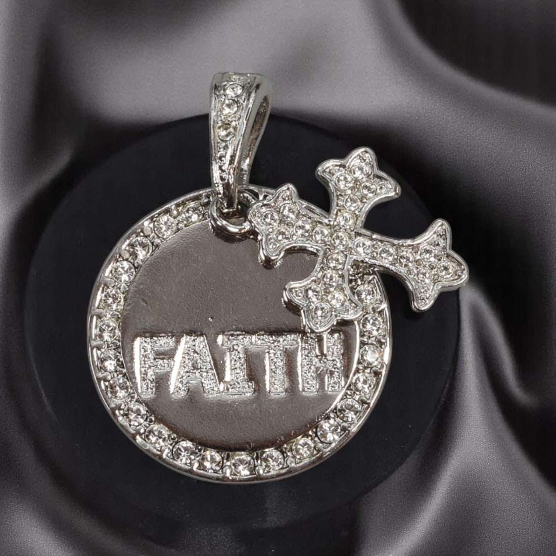 MODERN ROMANTIC: Pendant - "Faith" Round Drop with Clear Stone Cross, Silvertone (3.2x2.5cm): A radiant silvertone pendant that blends personal symbolism with polished flair, this modern charm features a circular disc engraved with the word "FAITH," bordered by clear brilliant-cut stones. A de