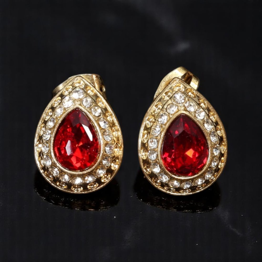 VINTAGE STATEMENT: Pierced Earrings - Ruby-Like Teardrops with Brilliant Clear Accents 1.6x1.4cm: From an estate collection, these vintage pierced earrings feature vivid ruby-like teardrop stones surrounded by pave-set brilliant-cut clear gems. The high-dome goldtone setting enhances the saturated
