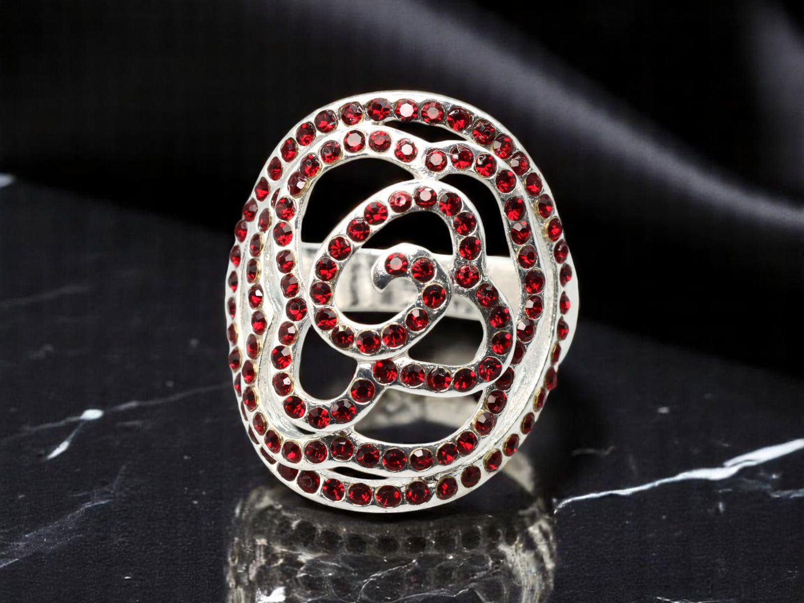 MODERN ROMANTIC: Openwork Rose Ring - Red Stones in Silvertone Scrollwork, Size 7 US: From a romantic estate collection, this bold openwork ring features a stylized rose silhouette rendered in swirling silvertone lines, each set with brilliant red stones. The abstract yet floral struct