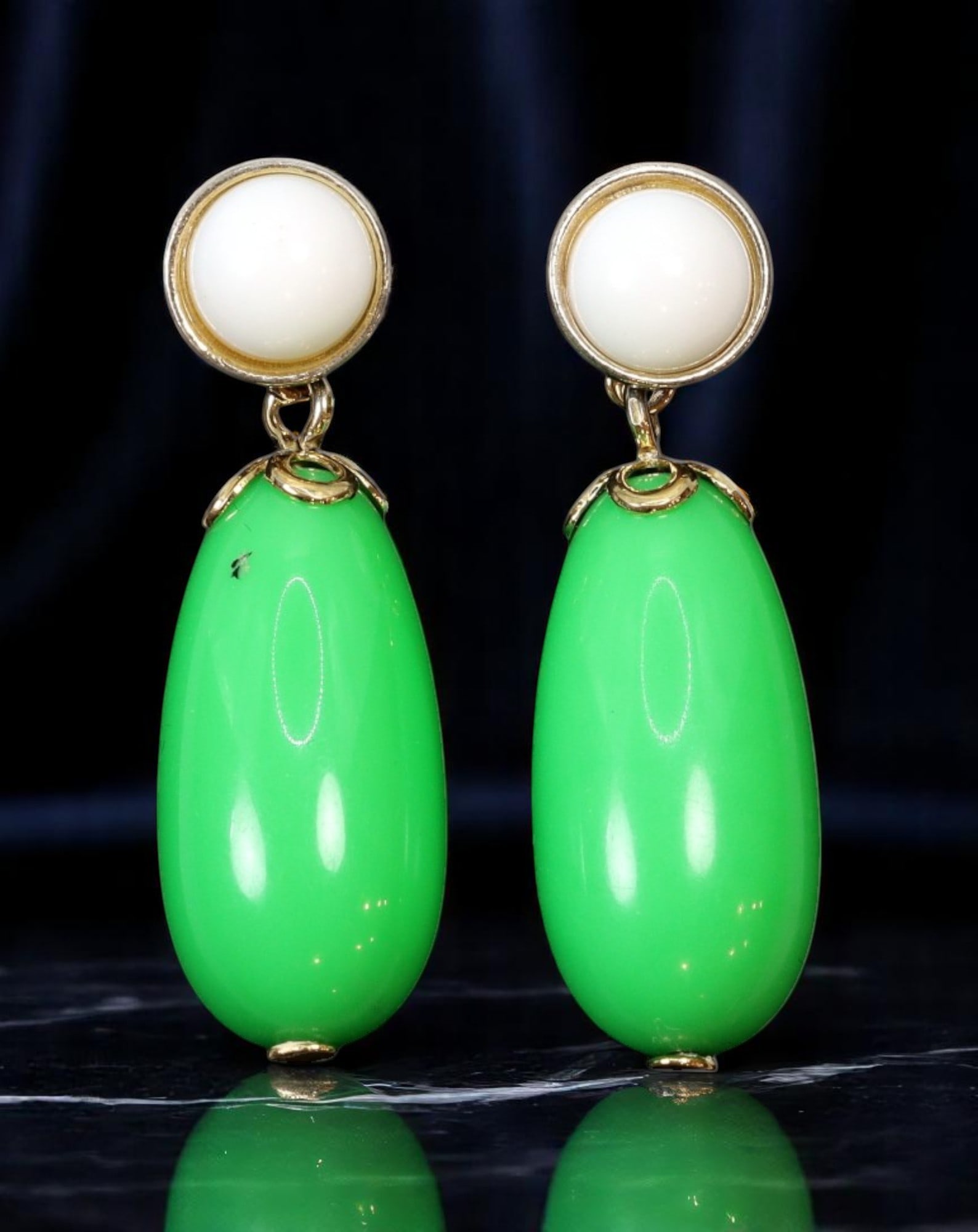 AVON: BOLD STATEMENT ERA Drop Earrings - Green Teardrop & Cream Dome in Goldtone, 3.5x1cm: Estate Jewelry from iconic brand Avon, these stamped vintage drop earrings embody bold late-century style with vibrant green teardrop forms suspended from creamy dome studs, all set in warm goldtone b