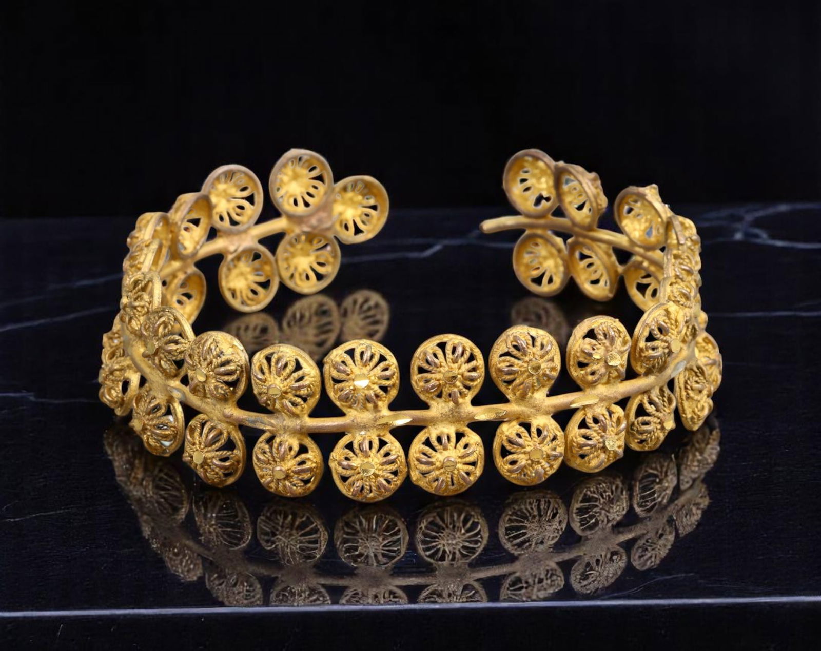 NATURE SYMBOLISM STYLE: Openwork Cuff Bracelet - Floral Disc Motif, Matte Goldtone (6 cm): This delicately sculpted cuff bracelet draws inspiration from natural forms, featuring an intricate series of openwork floral discs arranged in a rhythmic, organic flow. Cast in a softly matte goldton