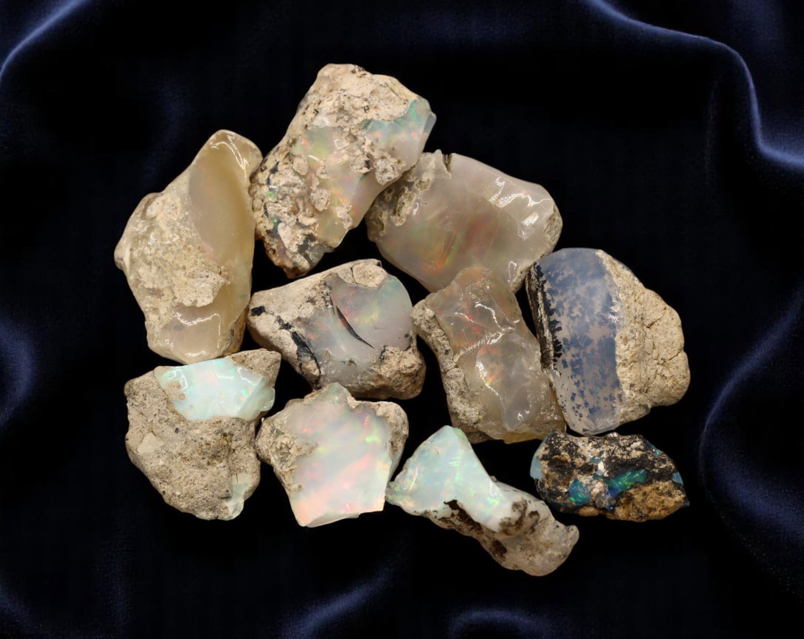 GEM LOT: Ethiopian Welo Opal Rough - Iridescent Play-of-Color in Matrix, Mixed Forms (13g): An estate-sourced parcel of natural Ethiopian Welo Opal rough, totaling 11 grams, this lot features raw, matrix-hosted specimens with vibrant play-of-color across milky, translucent, and honey-toned b