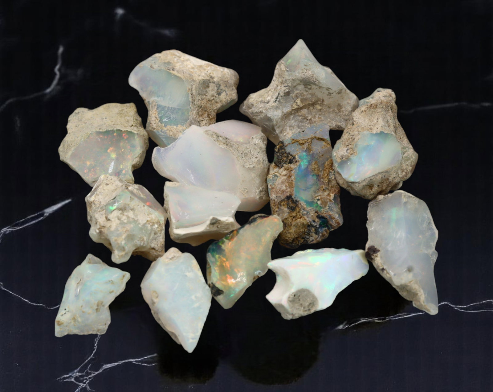 GEM LOT: Ethiopian Welo Opal Rough - Iridescent Play-of-Color in Matrix, Mixed Forms (10g): An estate-sourced parcel of natural Ethiopian Welo Opal rough, totaling 11 grams, this lot features raw, matrix-hosted specimens with vibrant play-of-color across milky, translucent, and honey-toned b