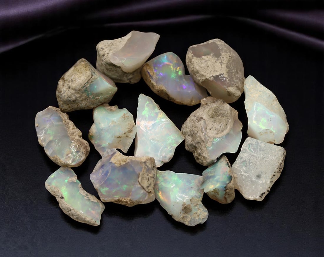GEM LOT: Ethiopian Welo Opal Rough - Iridescent Play-of-Color in Matrix, Mixed Forms (10g): An estate-sourced parcel of natural Ethiopian Welo Opal rough, totaling 11 grams, this lot features raw, matrix-hosted specimens with vibrant play-of-color across milky, translucent, and honey-toned b