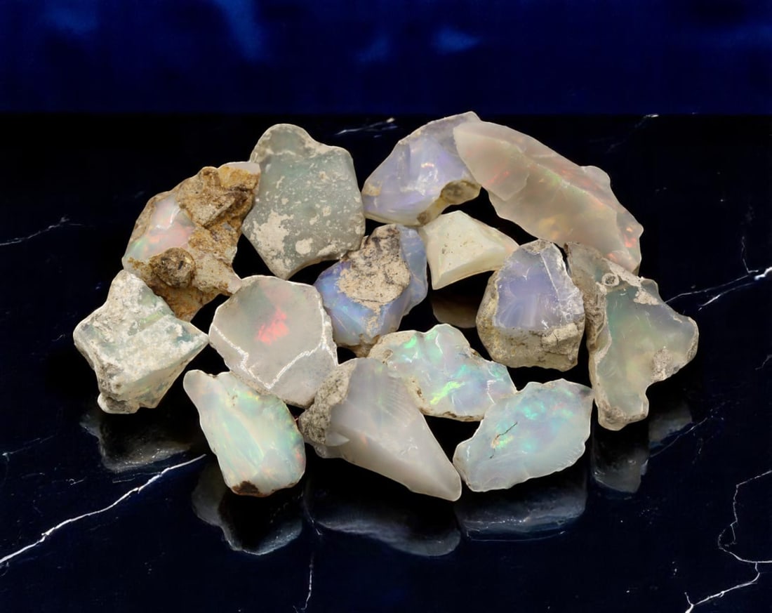GEM LOT: Ethiopian Welo Opal Rough - Iridescent Play-of-Color in Matrix, Mixed Forms (12g): An estate-sourced parcel of natural Ethiopian Welo Opal rough, totaling 11 grams, this lot features raw, matrix-hosted specimens with vibrant play-of-color across milky, translucent, and honey-toned b