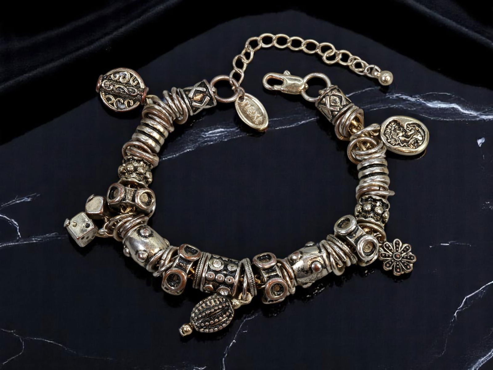 VINTAGE MIXED ERA: Bracelet - Sculptural Beads & Charms, Antiqued Goldtone, 20cm: An exceptionally curated bracelet showcasing a dynamic assembly of sculptural forms, this vintage piece features an abundant array of antiqued goldtone beads and charms. The design includes textured d