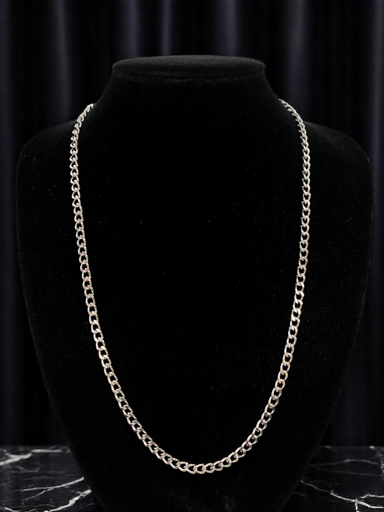 Necklace - Classic Curb Link Silvertone Chain, 55cm: A sleek and timeless essential, this contemporary silvertone necklace features a classic curb link design. The smooth interlocking links reflect light beautifully, offering a bold yet minimalist aesth