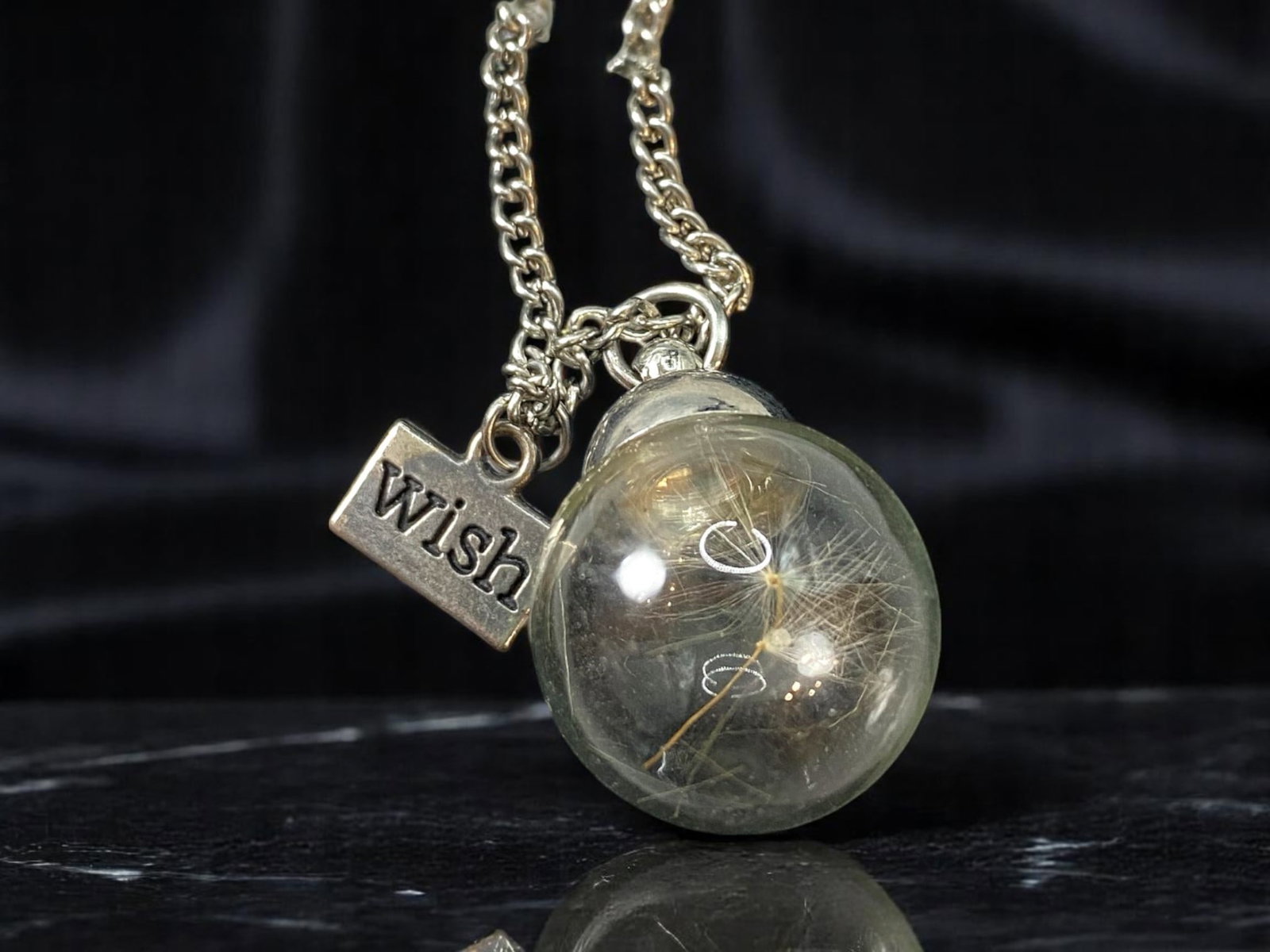 Necklace - Glass Orb Pendant with Botanical Inclusion, "Wish" Tag 60cm: From an estate jewelry collection, this modern romantic necklace captures a moment of wonder. Suspended on a silvertone chain, the clear glass orb pendant encases delicate plant-like wisps, evoking th