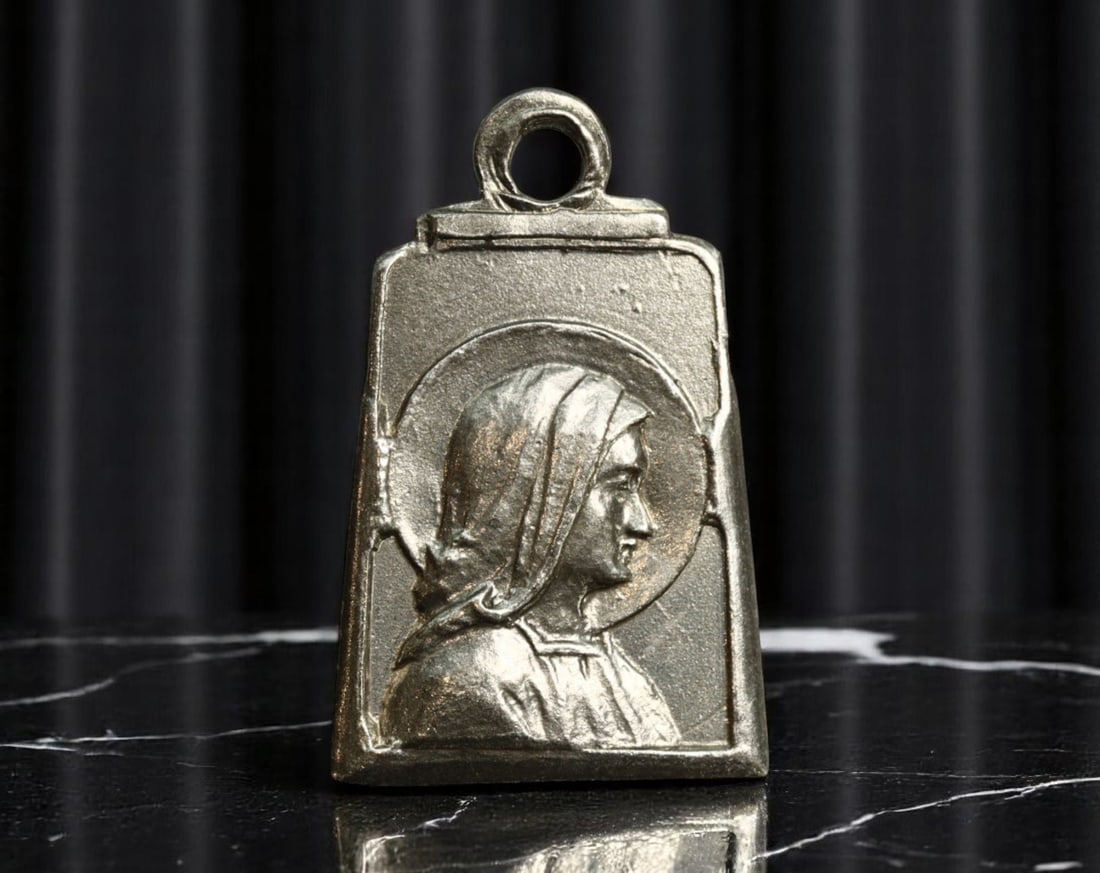 FRANCE: Marian Devotion - Stylized Virgin Mary Plaque Medal, c.1930s, 17mm: Struck in elegant Art Deco form, this French devotional medal from the interwar period evokes a deeply personal form of Marian reverence. The rectangular-flared silhouette contrasts with the intimate 