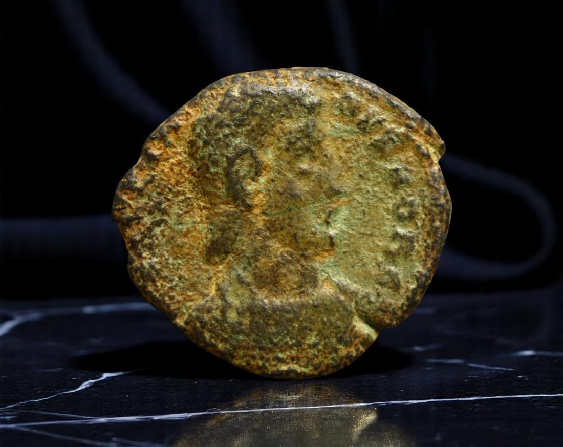 ROMAN EMPIRE: Ancient AE Coin Bronze Issue, 16mm: Issued during one of the most transformative epochs of the Roman Empire, this bronze coin embodies the endurance and adaptability of Roman statecraft across centuries. Its compact flan and timeworn su