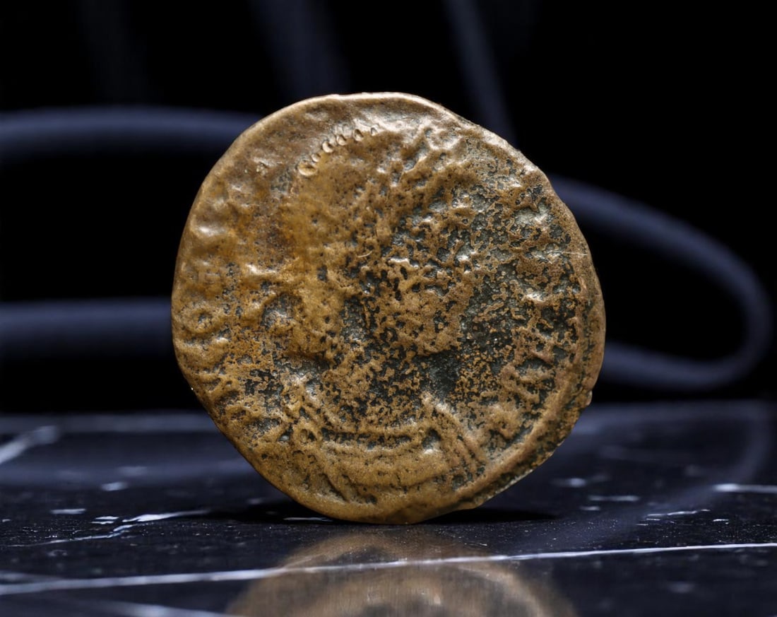 ROMAN EMPIRE: AE Coin Bronze Issue, 18mm: Issued during one of the most transformative epochs of the Roman Empire, this bronze coin embodies the endurance and adaptability of Roman statecraft across centuries. Its compact flan and timeworn su