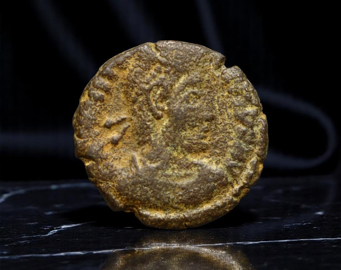 ROMAN EMPIRE: Ancient AE Coin Bronze Issue, 16mm: Issued during one of the most transformative epochs of the Roman Empire, this bronze coin embodies the endurance and adaptability of Roman statecraft across centuries. Its compact flan and timeworn su