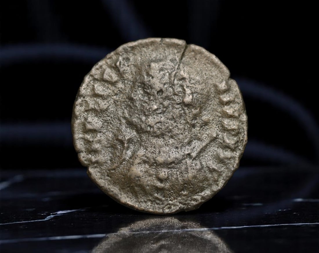 ROMAN EMPIRE: Ancient AE Coin Bronze Issue, 18mm: Issued during one of the most transformative epochs of the Roman Empire, this bronze coin embodies the endurance and adaptability of Roman statecraft across centuries. Its compact flan and timeworn su