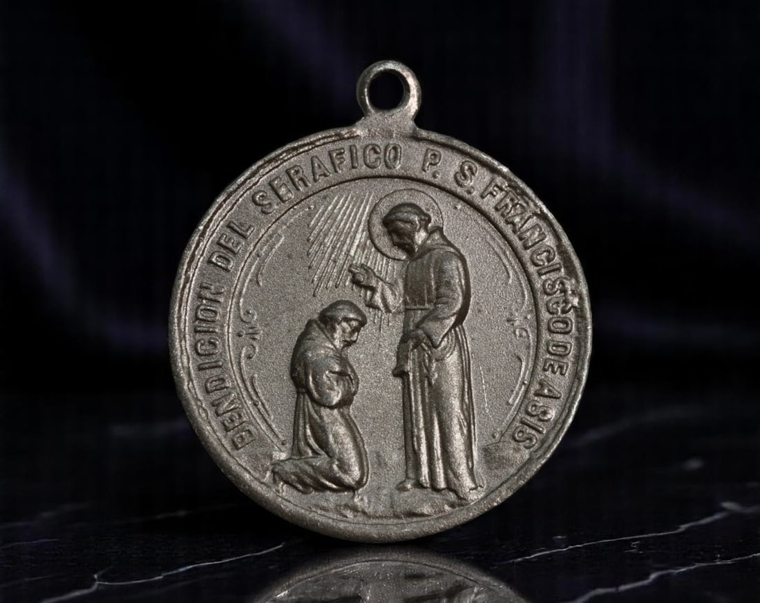 SPAIN: Franciscan Devotion - Medal of the Blessing of St. Francis of Assisi, 30mm: Struck in the spirit of humility and divine intercession, this Franciscan devotional medal depicts St. Francis of Assisi imparting a radiant blessing to a kneeling friar. Surrounded by the inscription