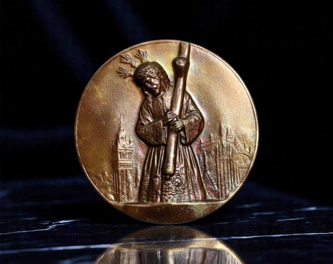 SPAIN: Semana Santa Devotion - Nazarene Plaque Medal, ca. Early 20th Century, 30mm: Struck in quiet reverence and rich with regional devotion, this 30mm bronze medal captures a poignant moment from Spain's Semana Santa (Holy Week), one of the most elaborate and emotionally charged re