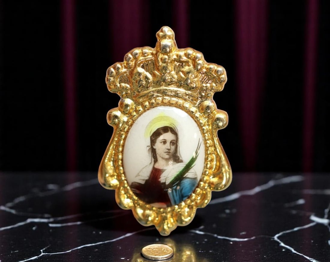 SPAIN: Virgin Martyr - Crowned Enamel Devotional Brooch Medal Coin, c.1950s, 23mm: This ornate devotional brooch fuses traditional Spanish piety with mid-century enamel craftsmanship. Framed in a regal gilded setting surmounted by an openwork crown, the piece showcases a hand-colore
