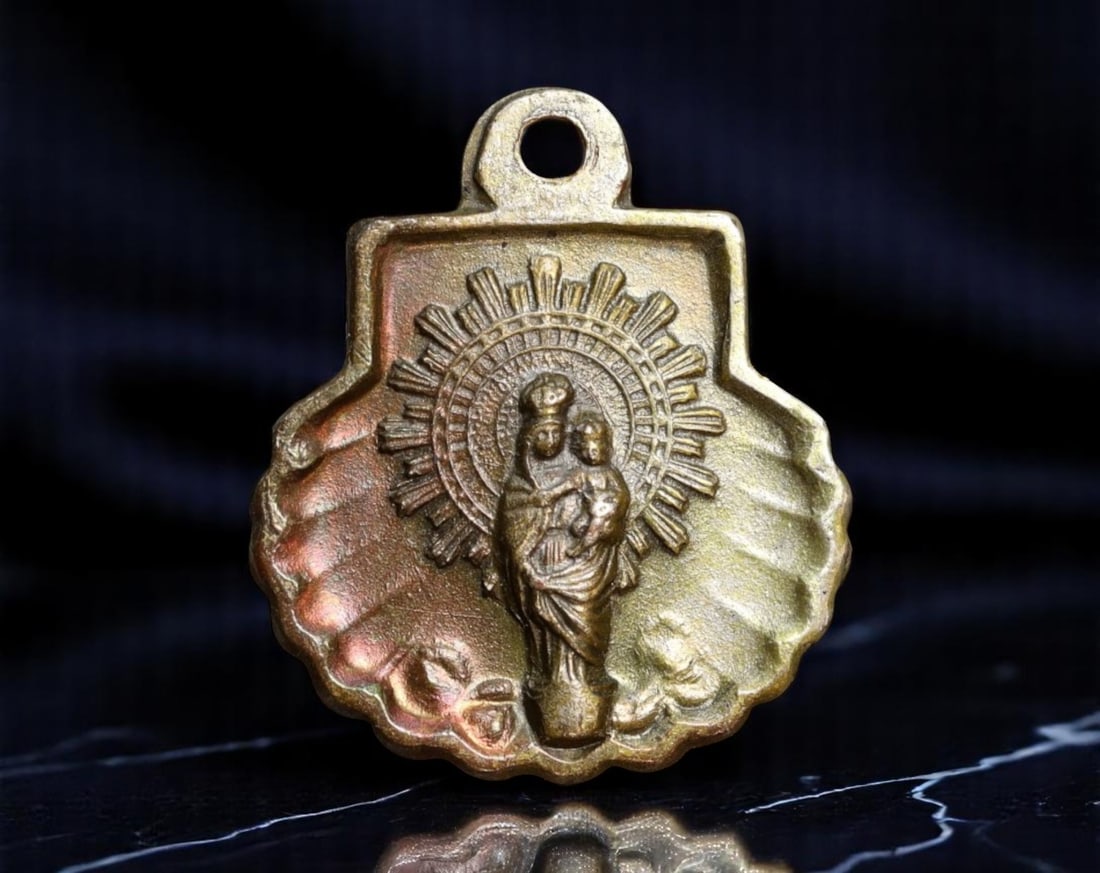 SPAIN: Marian Devotion - Virgen del Pilar Shell-Shaped Pilgrimage Medal, ca. Early 20th Century,: Struck in the iconic scallop-shell form associated with pilgrimage to Santiago and other sacred Spanish routes, this devotional medal honors the Virgen del Pilar, protector of the Hispanic world. The 