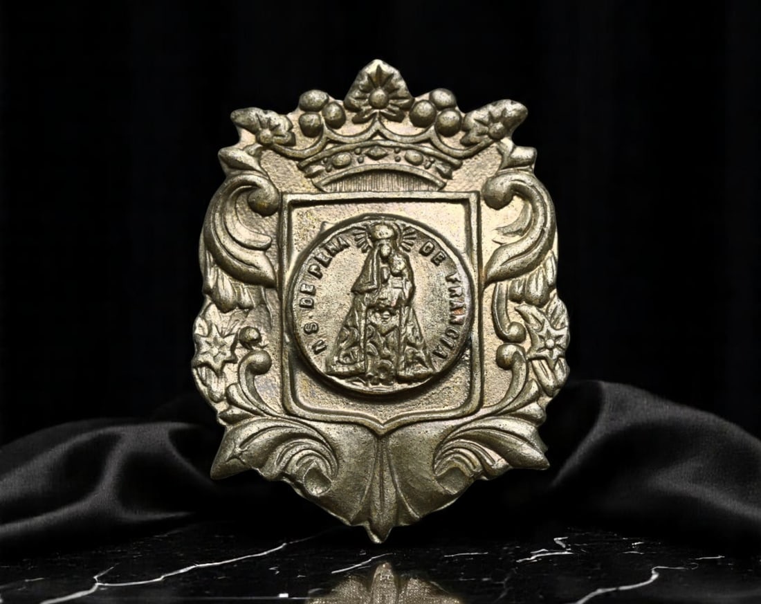 SPAIN: Virgen de los Desamparados - Valencian Patronage Devotional Badge, Early 20th Century, 25mm: Set within a regal, heraldic-style frame topped by an ornate crown, this devotional badge honors the Virgen de los Desamparados (Our Lady of the Forsaken), the patroness of Valencia. At the center, th