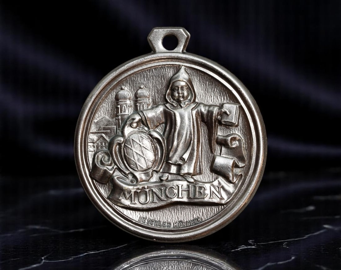 GERMANY/BAVARIA: Munich Civic Emblem and Cityscape Commemorative Medal, c.20th Century, 42mm: This finely cast commemorative medal honors the civic identity of Munich, showcasing the city's monastic symbol-the "Munchner Kindl"-cloaked and holding the Bavarian lozenge shield, a fusion of religi