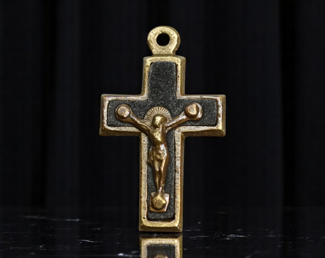 ITALY: Passion of Christ - Brass Crucifix Devotional Pendant, ca. Mid-20th Century, 27mm: This mid-century Italian crucifix pendant captures the solemnity of the Passion with minimalist contrast and tactile depth. Struck in brass with a blackened enamel inlay, the figure of Christ is rende