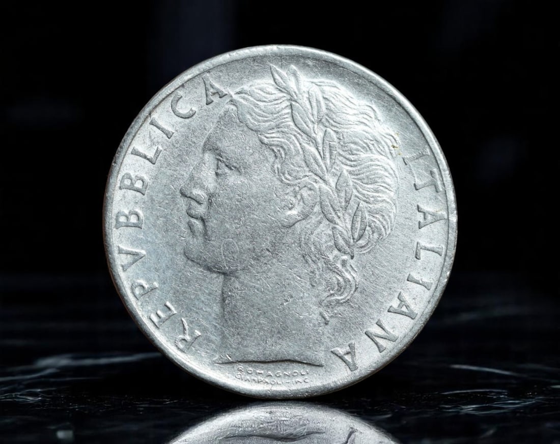ITALY: Republic - Minerva Standing 100 Lire Coin, 1974 R (28mm): Issued by the Italian Republic in 1974, this 100 Lire coin features a left-facing bust of Italia, crowned with laurel, symbolizing civic virtue and national pride. The reverse showcases the Roman godd