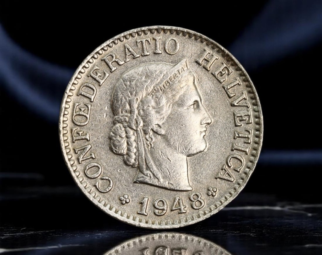 SWITZERLAND: Helvetia Allegory - Postwar Liberty 10 Rappen Coin, 1948, 19mm: Struck in the wake of World War II, this 10 Rappen coin from 1948 quietly embodies the enduring Swiss ideals of neutrality and civic virtue. The obverse features the serene profile of Helvetia-Switzer