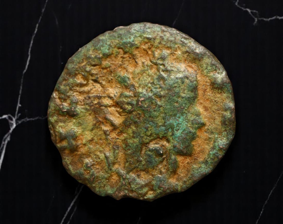 ROMAN EMPIRE: Ancient AE Coin Bronze Issue, 18mm: Issued during one of the most transformative epochs of the Roman Empire, this bronze coin embodies the endurance and adaptability of Roman statecraft across centuries. Its compact flan and timeworn su