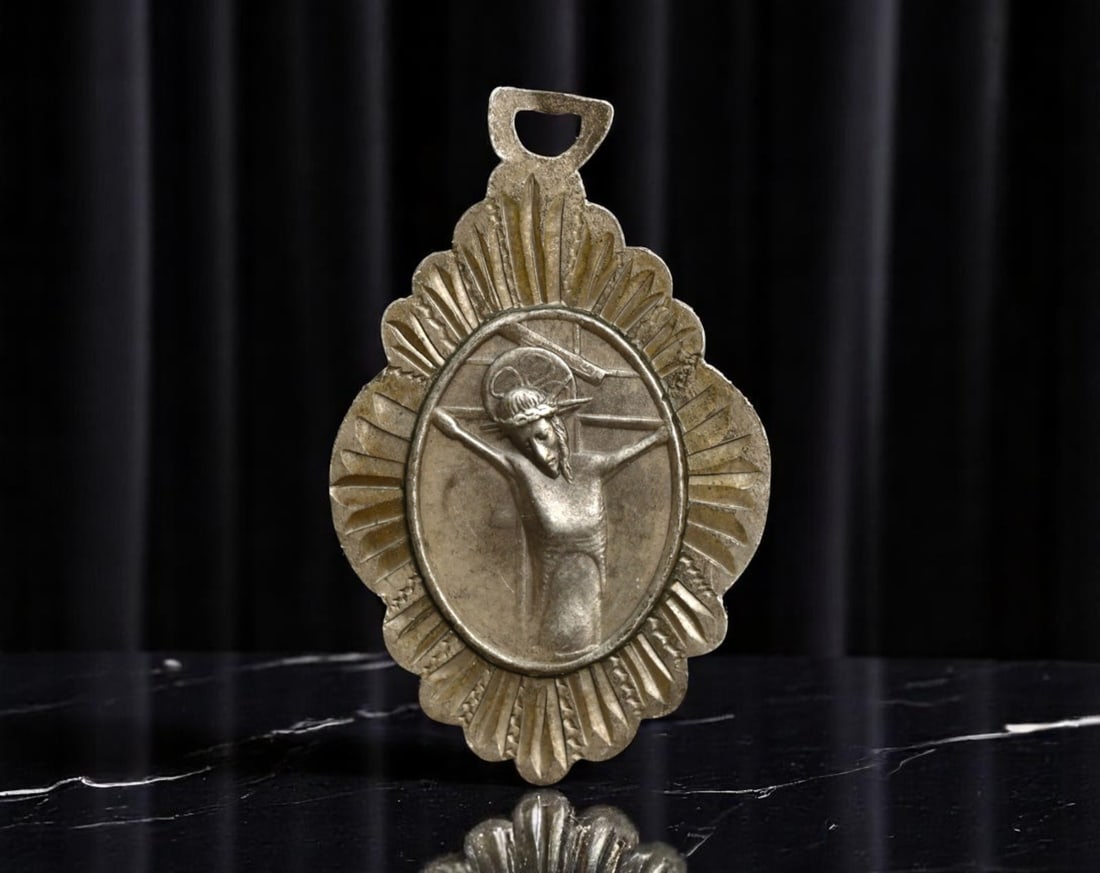 SPAIN: Passion Devotion - Christ Crucified Medal "Rdo Balaguer", ca. 1950s, Silver, 30mm: Radiating from a stylized sunburst cartouche, this Spanish devotional medal casts Christ in the moment of crucifixion, his bowed head encircled by a halo of quiet divinity. The design is boldly framed