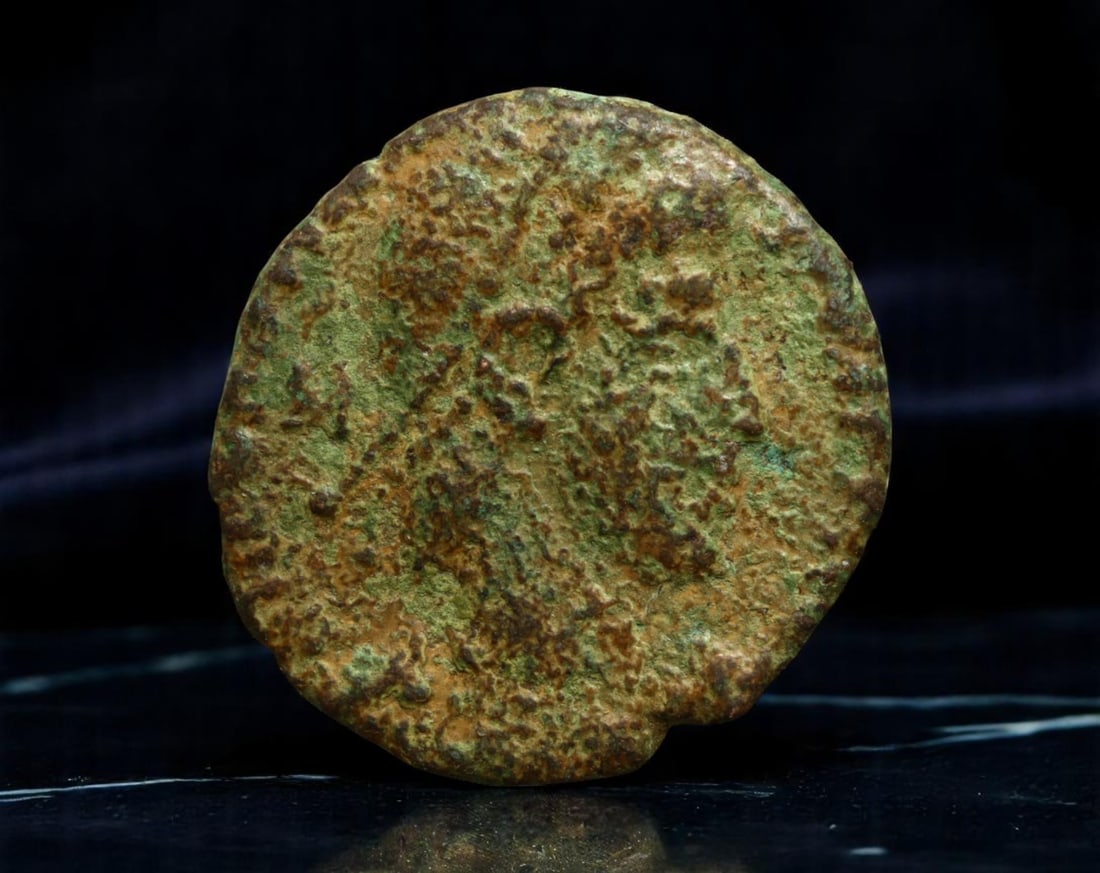 ROMAN EMPIRE: Ancient AE Coin Bronze Issue, 16mm: Issued during one of the most transformative epochs of the Roman Empire, this bronze coin embodies the endurance and adaptability of Roman statecraft across centuries. Its compact flan and timeworn su