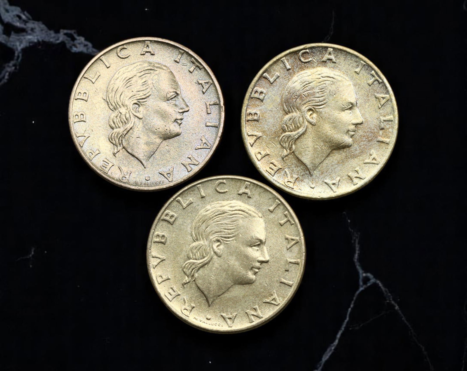 ITALY: Industrial Progress - 200 Lire Coin Lot, 1978-1991, 24mm: This attractive lot of three Italian 200 Lire coins captures the spirit of post-war Italian industrial and cultural resurgence. Issued between 1978 and 1991, these coins feature the iconic neoclassica