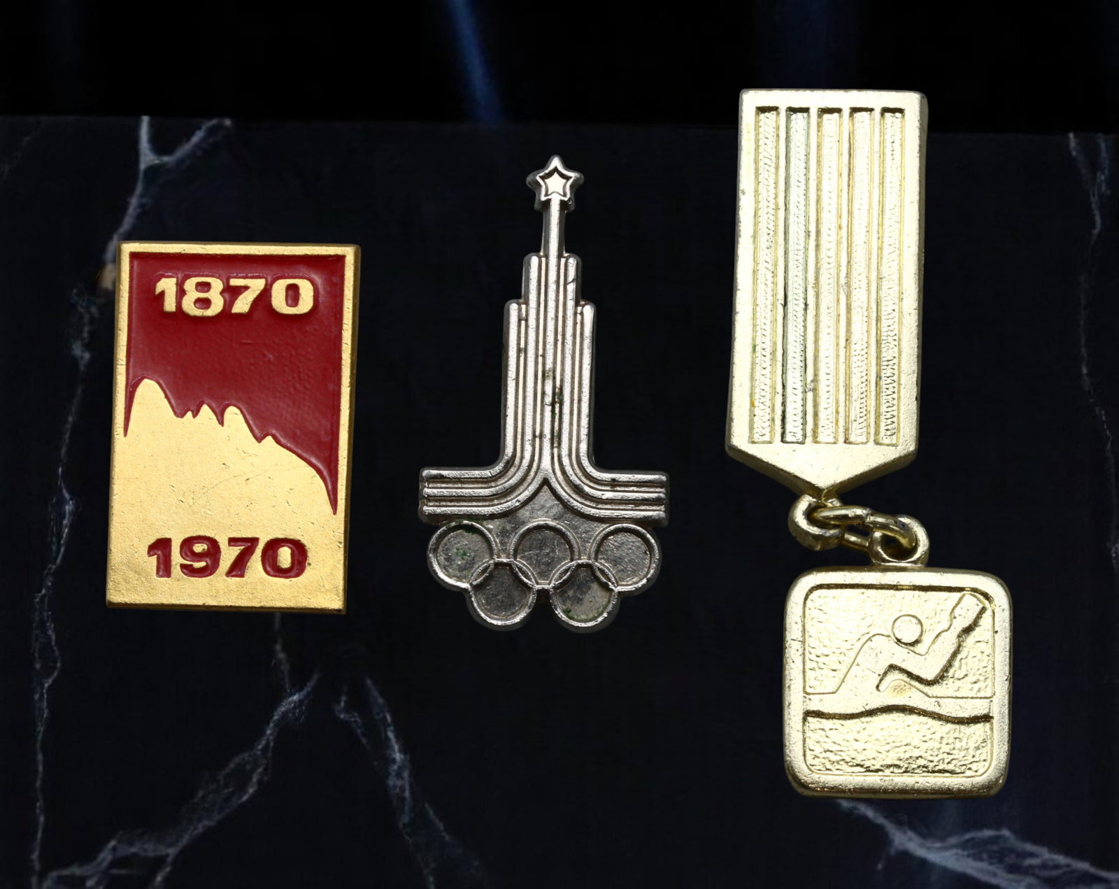 USSR: Lenin Centenary, Moscow Olympics and Swimming Sports Award Badges, 1970s, 20-38mm: This trio of badges celebrates key milestones in Soviet ideological and sporting pride. The vivid red and gold badge marks the 100th anniversary of Vladimir Lenin's birth in 1870, an event central to 