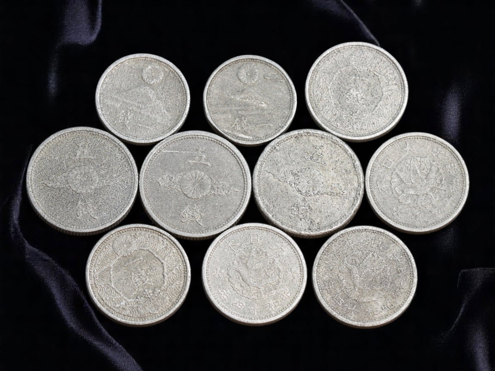 JAPAN/SHOWA ERA: Chrysanthemum Crest - National Reconstruction 1 Sen Coins, c.1938-1945, 15-18mm: Struck during the turbulent years of the Showa era under Emperor Hirohito, this matched group of ten 1 Sen coins embodies Japan's wartime mobilization and symbolic resilience. Each piece is anchored b