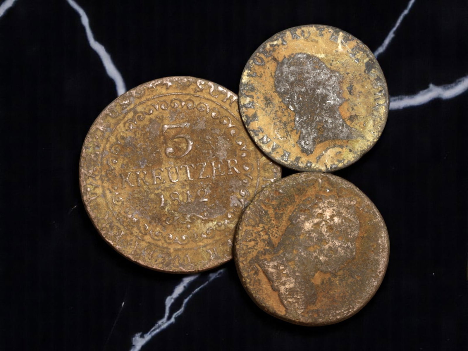 AUSTRIA: Napoleonic Era - Habsburg Fiscal Authority 3-Kreutzer Coins, 1800s, 24-31mm: Struck amidst the geopolitical upheaval of Napoleonic Europe, this trio of Austrian 3-Kreutzer coins serves as a numismatic echo of imperial resilience. Anchored by a clear 1812 issue, each coin carri