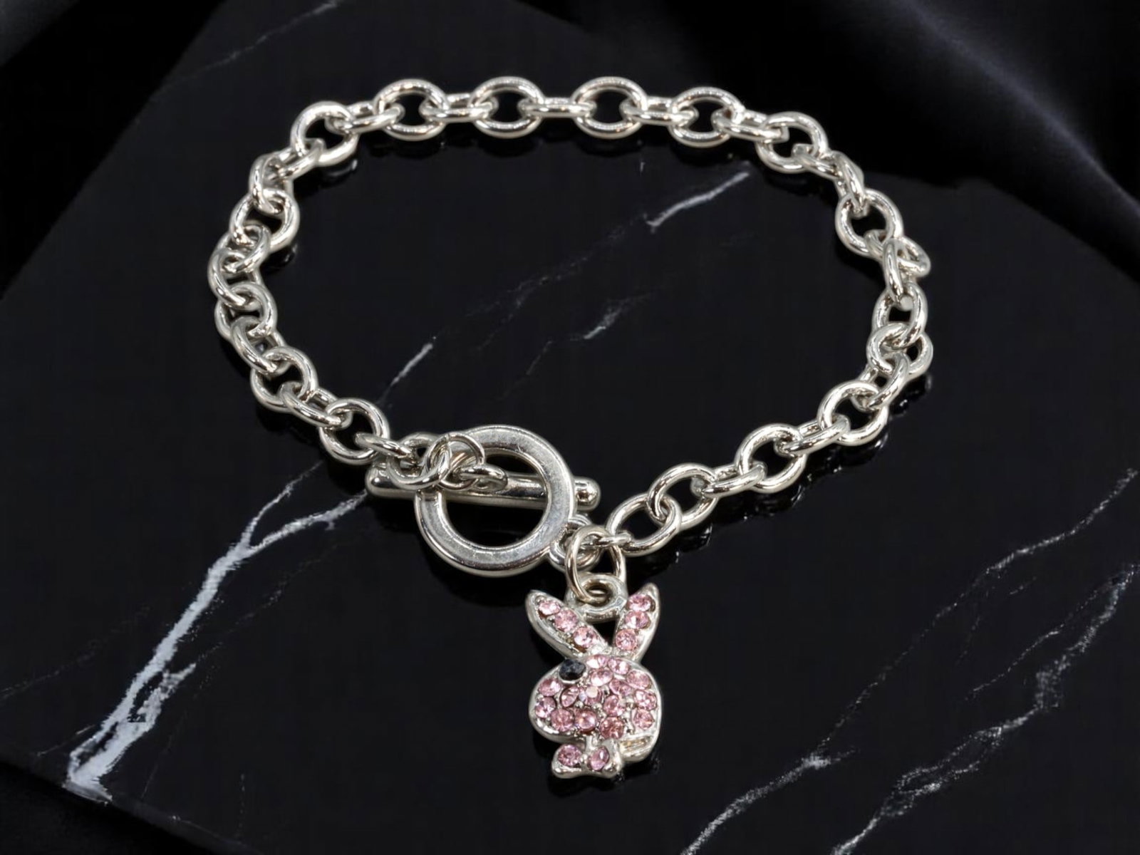 VINTAGE Y2K: Bracelet - Iconic Bunny Motif, Silvertone Chain, 20.5cm: A standout accessory evoking the playful glamour of the early 2000s, this vintage bracelet features a bold silvertone rolo chain with an oversized toggle clasp and a sculptural bunny charm. The charm 