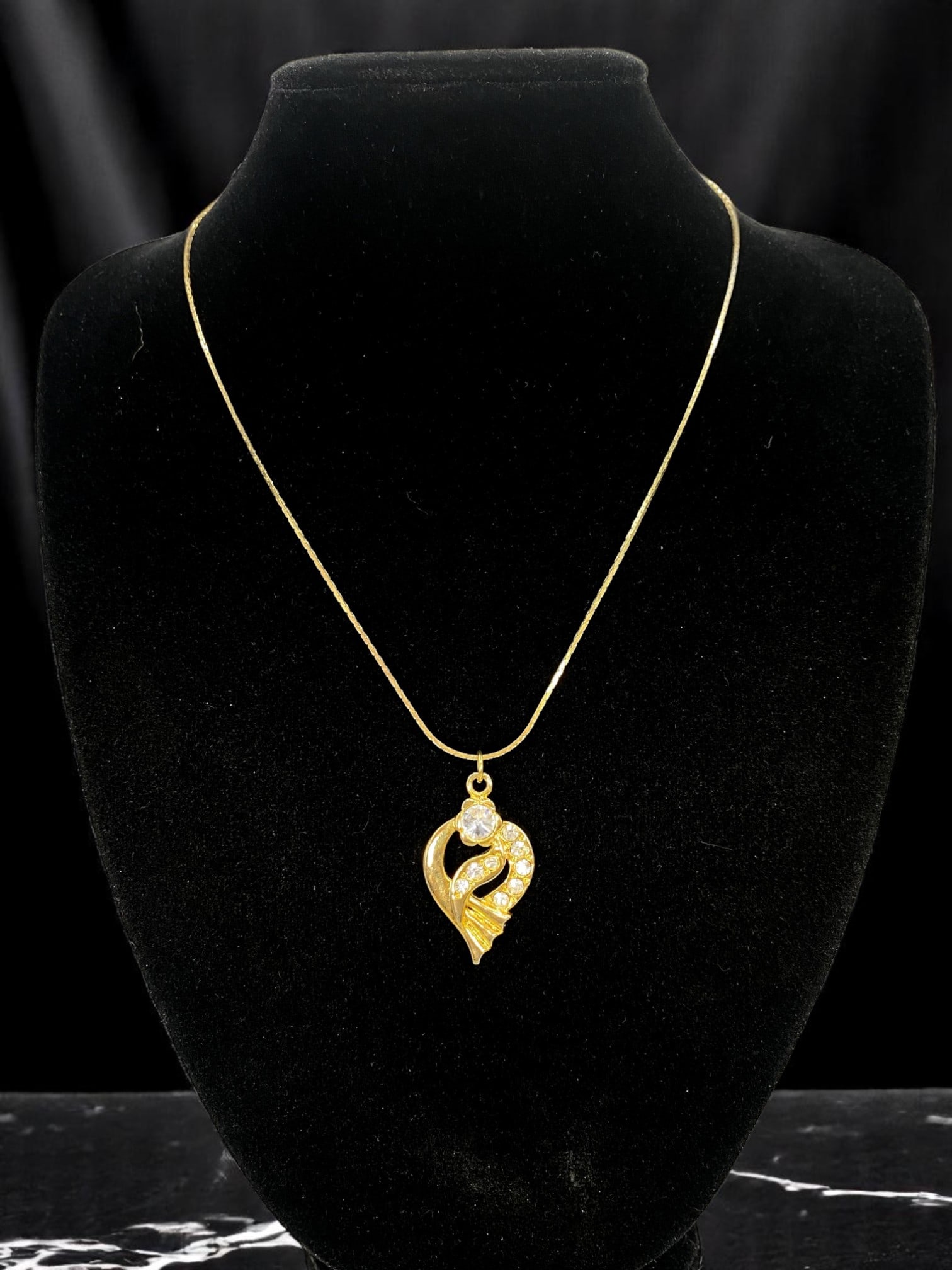 Necklace - Heart Motif Pendant, Clear Stone Accents, Goldtone Chain 42cm: From an estate jewelry collection, this modern romantic necklace pairs soft symbolism with refined sparkle. Suspended from a delicate goldtone chain, the heart-shaped pendant features flowing lines ac