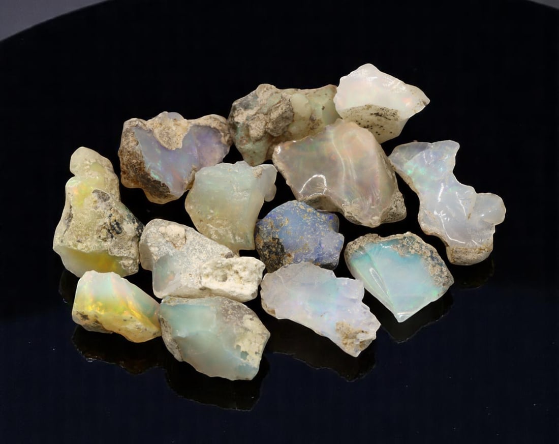 GEM LOT: Ethiopian Welo Opal Rough - Iridescent Play-of-Color in Matrix, Mixed Forms (11g): An estate-sourced parcel of natural Ethiopian Welo Opal rough, totaling 11 grams, this lot features raw, matrix-hosted specimens with vibrant play-of-color across milky, translucent, and honey-toned b