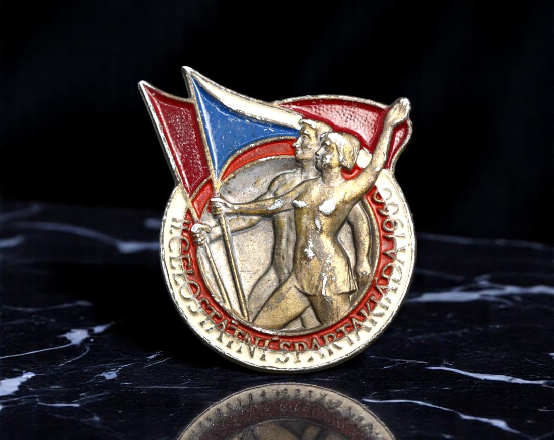 USSR: International Spartakiad - Worker and Athlete Unity Commemorative Pin, 1930, 35mm: A bold emblem of the early Soviet drive to unite labor and athletic excellence, this large-format commemorative pin was issued for the historic 1930 International Spartakiad. Designed with neoclassica