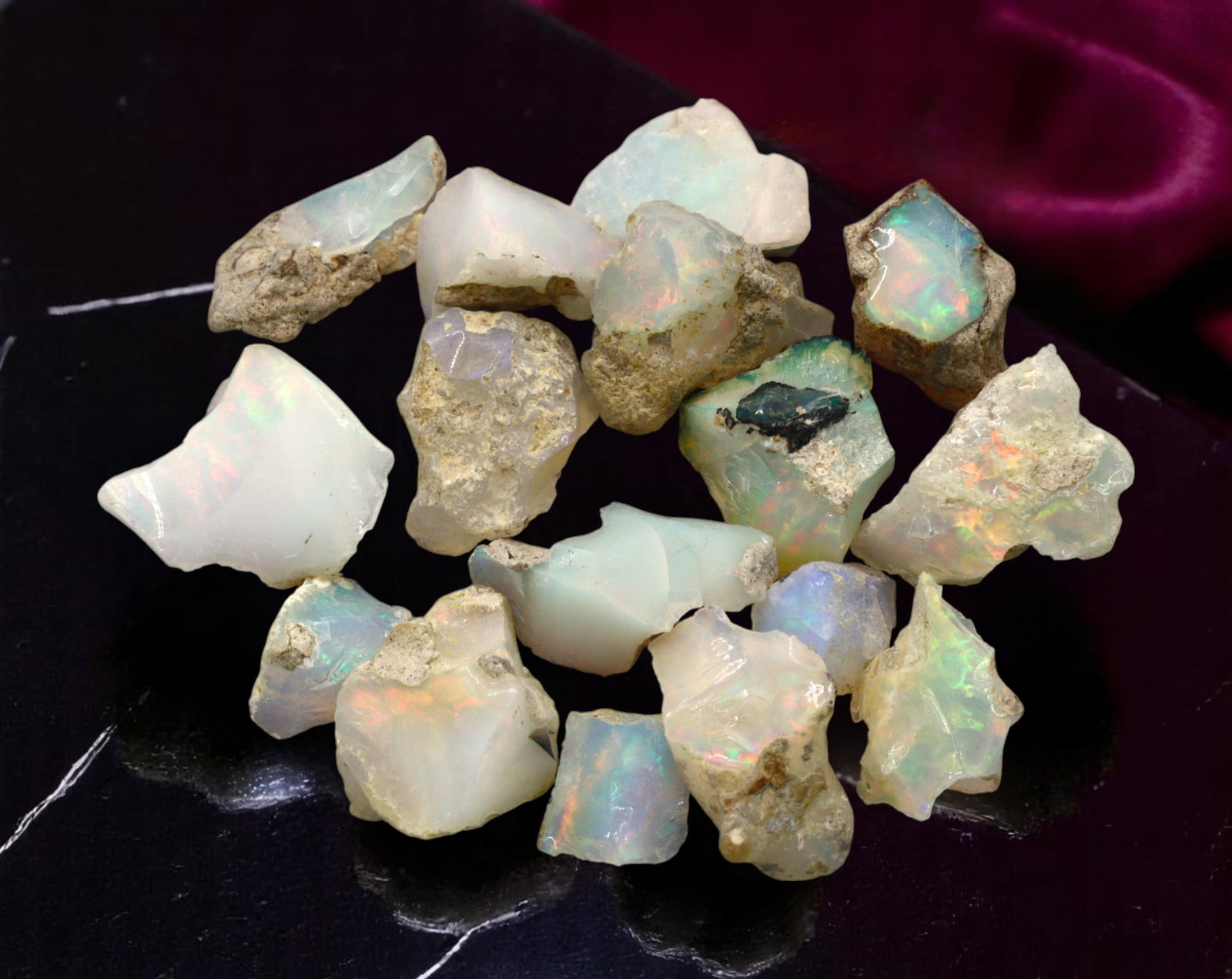 GEM LOT: Ethiopian Welo Opal Rough - Iridescent Play-of-Color in Matrix, Mixed Forms (8g): An estate-sourced parcel of natural Ethiopian Welo Opal rough, this lot features raw, matrix-hosted specimens with vibrant play-of-color across milky, translucent, and honey-toned bodies. Flashes of g