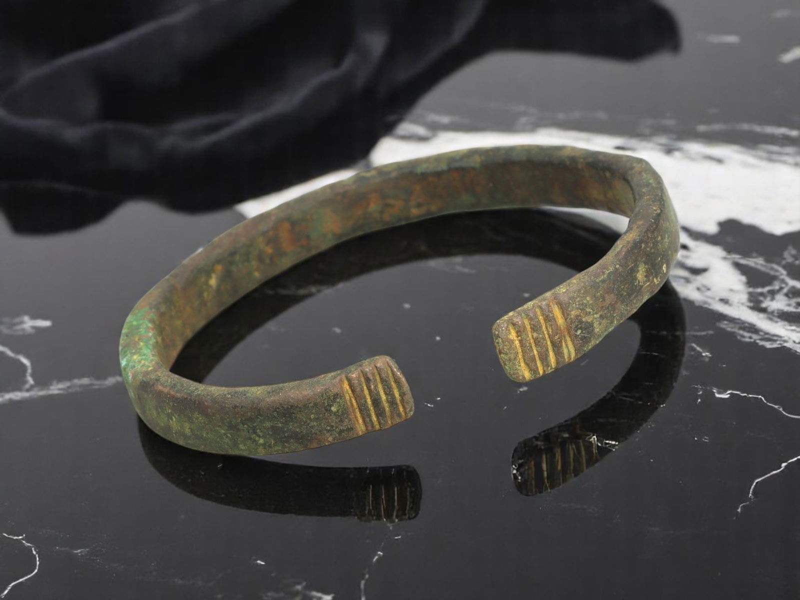 ANCIENT CELTIC / ROMAN PROVINCIAL Terminal-Banded Bronze Bracelet, 6.5 cm: Robust in form and symbolic in detail, this ancient open bronze bracelet features flattened terminals each incised with three uniform bands-echoing ritual or rank indicators common in frontier Celtic