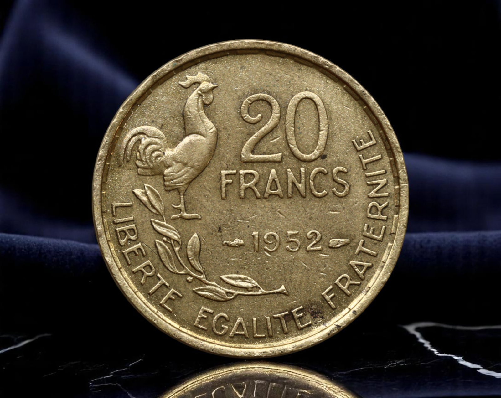 FRANCE: Republican Liberty - Gallic Rooster 20 Francs Coin, 1952, 23mm: Struck in the postwar era of national reconstruction, the 1952 French 20 Francs coin radiates the core values of the Republic through iconic symbolism. On one side, the Gallic Rooster stands proud upo