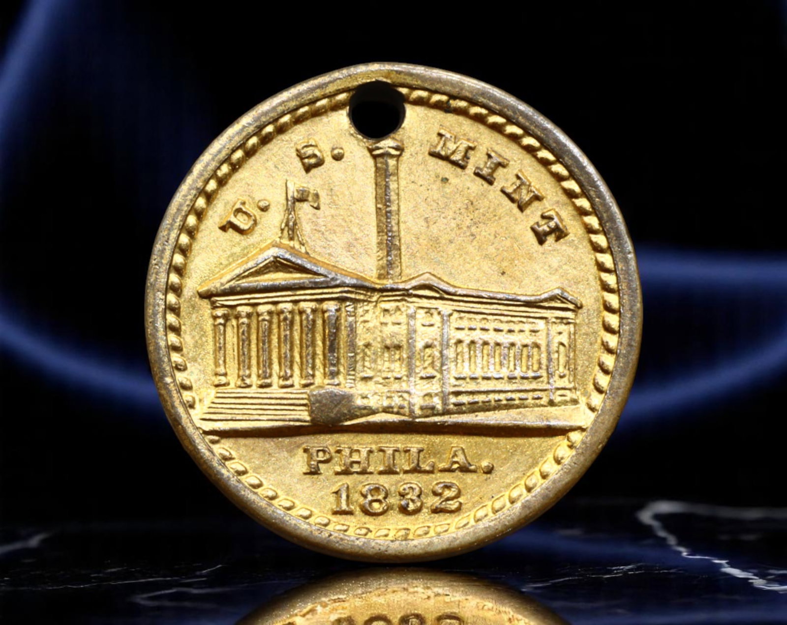 UNITED STATES: Early American Devotional - U.S. Mint Philadelphia "Lord's Prayer" Token, 1832, 13mm: Struck in miniature yet steeped in symbolism, this 1832 token commemorates the original U.S. Mint building in Philadelphia-an emblem of early American economic sovereignty. The neoclassical facade is 