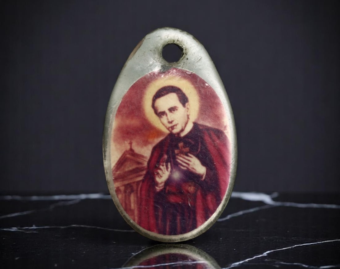 UNITED STATES: Saintly Legacy - Relic Medal of St. John Neumann with Cloth Fragment, c.20th C, 20mm: This 20mm devotional relic medal honors St. John Neumann, the fourth Bishop of Philadelphia and the first American male saint to be canonized. On the obverse, a vivid enameled portrait of Neumann in e