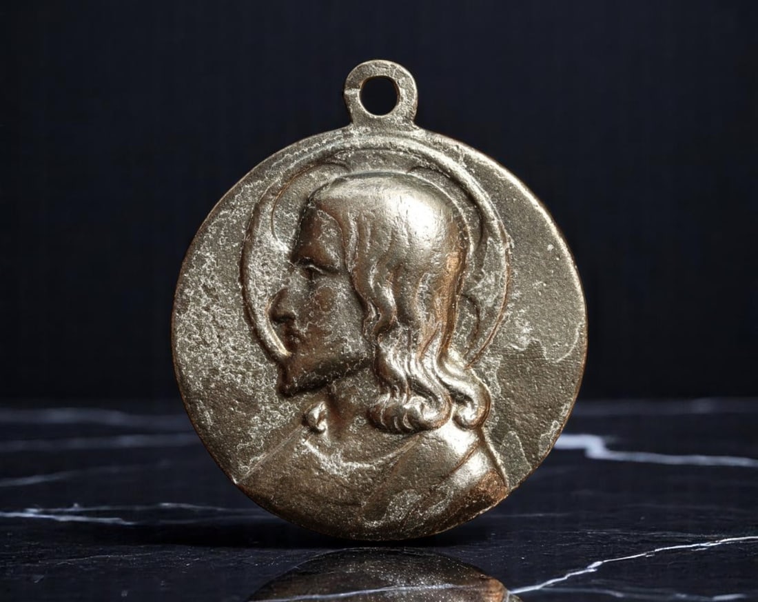 ITALY: Divine Compassion - Christ and Virgin Mary Devotional Medal, ca. Early 20th Century, 32mm: Quietly powerful in its simplicity, this 32mm devotional medal presents paired profiles of Christ and the Virgin Mary, their visages rendered in contemplative, softly modeled relief. One side depicts 