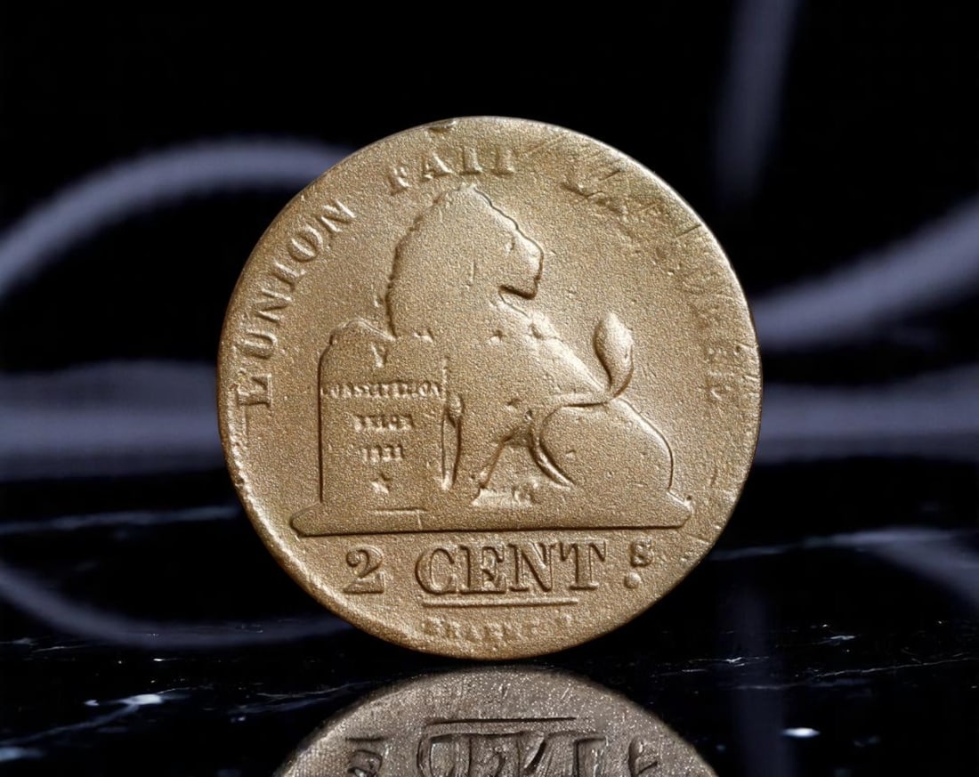BELGIUM: Leopold I - Union and Strength 2 Centimes Coin, 1863, 21mm: Struck amid Belgium's first decades of independence, this 1863 2 Centimes coin embodies the young nation's ideals of unity and resilience. The obverse presents a proud Belgian lion seated beside a Con